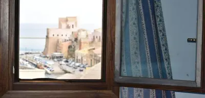 a window with a view of a city street at la palma in Castellammare del Golfo
