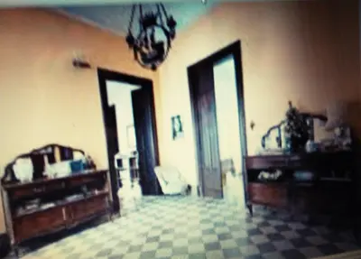 a living room with two doors and a room with a couch at Rosella Bianchi in Palermo