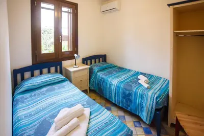 a bedroom with two beds and a window at SanvitoTour - Oasi nel Mare in San Vito lo Capo