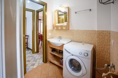 a bathroom with a washing machine and a sink at SanvitoTour - Oasi nel Mare in San Vito lo Capo