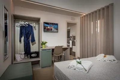 a hotel room with a bed and a desk in it at Affittacamere Nanà in Castellammare del Golfo