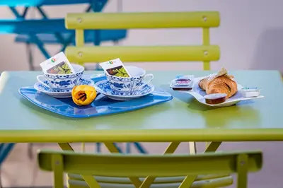 a table with two plates of food and cups of coffee at Affittacamere Nanà in Castellammare del Golfo