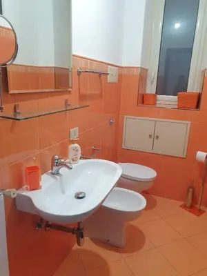 a bathroom with a sink and a toilet at A Casa Tua in Palermo