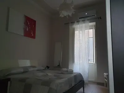 a bedroom with a bed and a window at A Casa Tua in Palermo