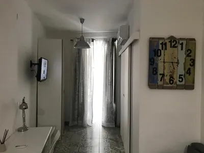 a hallway with a window and a clock on the wall at Sweet home Ballaro' in Palermo