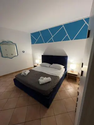 a bedroom with a bed with two towels on it at Cartari Apartment in Palermo