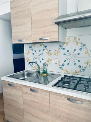 a kitchen with a sink and a stove at Cartari Apartment in Palermo