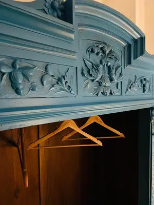 a blue console table with a wooden drawer at Cartari Apartment in Palermo
