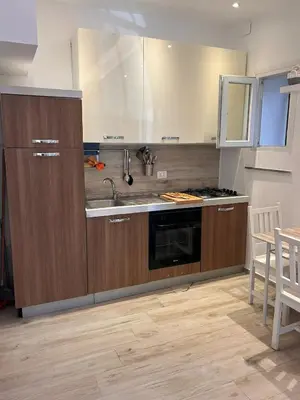 a kitchen with a sink and a stove at casa vacanza roberto in Palermo