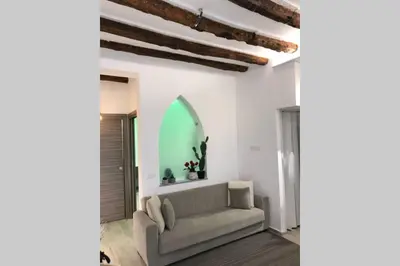 a living room with a couch and a window at casa vacanza roberto in Palermo