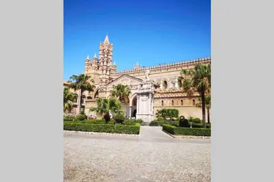 a building with a clock tower on top of it at casa vacanza roberto in Palermo