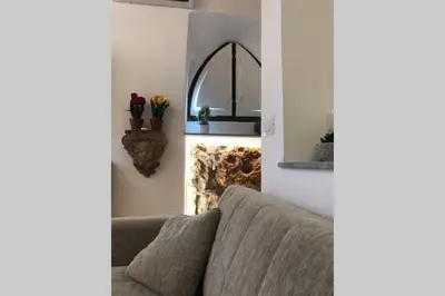 a living room with a couch and a fireplace at casa vacanza roberto in Palermo