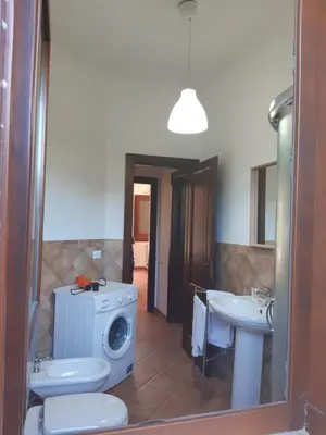 a bathroom with a washing machine and a sink at Campofelice Holidays in Campofelice di Roccella