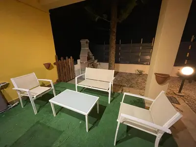 three white chairs and a table and a table and chairs at Villa Torre Magaggiari in Cinisi