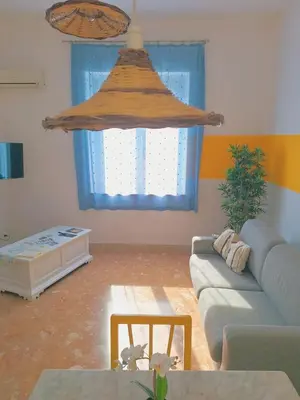 a living room with a couch and a window at Vento di Grecale - a pochi metri dal mare in Santa Flavia