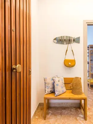 a room with a bench and a surfboard on the wall at Vento di Grecale - a pochi metri dal mare in Santa Flavia