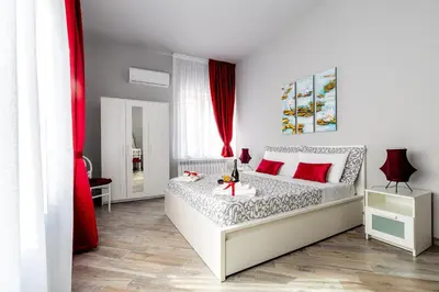 a bedroom with a large bed with red pillows at Dream Home in Palermo