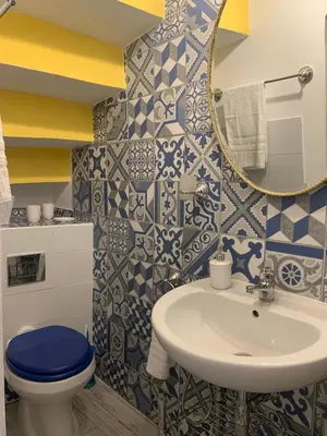 a bathroom with a sink and a toilet and a mirror at Le Lanterne di Terrasini in Terrasini