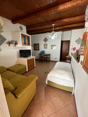 a bedroom with a bed and a couch at Casa Vacanze Salvatore in Balestrate