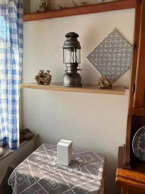 a room with a table with a lantern on a shelf at Casa Vacanze Salvatore in Balestrate