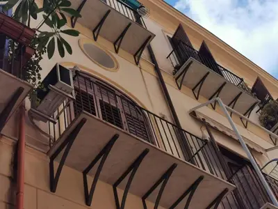 a building with balconies on the side of it at Diatomea in Palermo