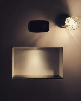 a metal shelf with a light on a wall at B&B Angolo83 Palermo centro in Palermo