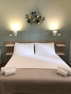 a bedroom with a large bed with two towels on it at B&B Angolo83 Palermo centro in Palermo