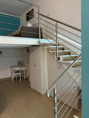 a spiral staircase in a room with a table at Casa vacanza toledo in Partinico