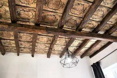 a chandelier hanging from the ceiling of a room at Casta Diva Luxury Apartments -Self check-in in Palermo