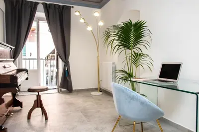 a room with a desk with a laptop and a plant at Casta Diva Luxury Apartments -Self check-in in Palermo