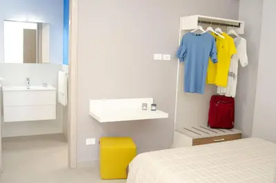 a bedroom with a bed and a sink and a mirror at Solemare Casa Vacanze in Castellammare del Golfo