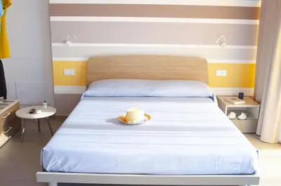 a bedroom with a bed with a hat on it at Solemare Casa Vacanze in Castellammare del Golfo