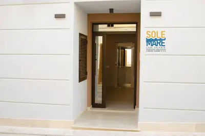 a door in a building with a sale sign on it at Solemare Casa Vacanze in Castellammare del Golfo