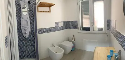 a bathroom with a shower with blue and white tiles at La casetta di Mavi in Palermo