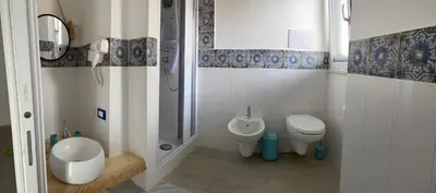 a small bathroom with a toilet and a sink at La casetta di Mavi in Palermo