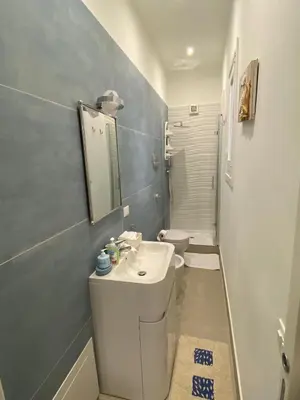 a bathroom with a white sink and a toilet at Josh's House Mondello in Mondello