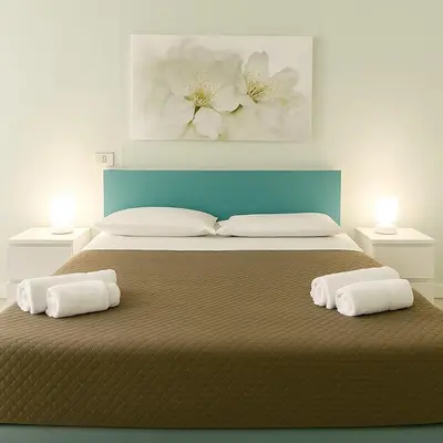 a bedroom with a large bed with two pillows at B&B La Tua Dimora in Palermo