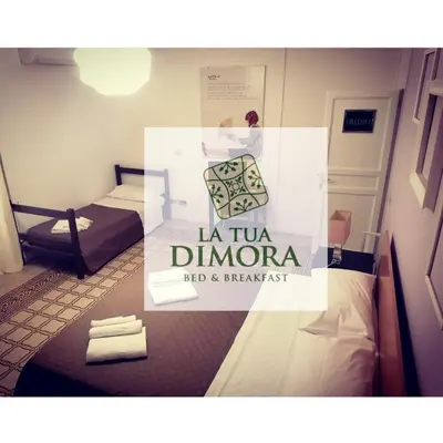 a room with a sign that reads la tu divina red and breakfast at B&B La Tua Dimora in Palermo