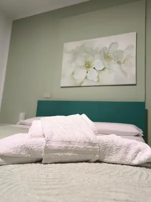 a bed with white towels on top of it at B&B La Tua Dimora in Palermo