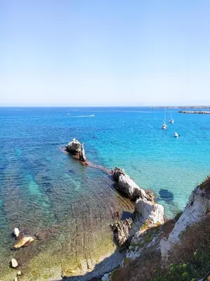 a body of water with rocks and boats in it at A casa di nonna Maria in Terrasini