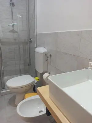 a bathroom with a toilet and a shower and a sink at A casa di nonna Maria in Terrasini