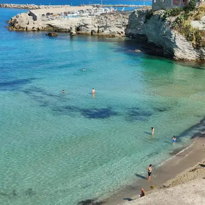 a group of people in the water at a beach at A casa di nonna Maria in Terrasini