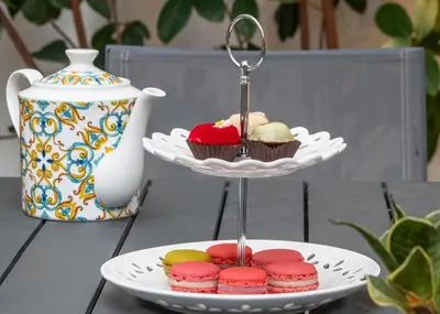 a plate of cupcakes on a stand on a table at Dc Domus Charme SPA in Palermo