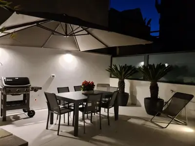 a patio with a table and chairs and a grill at Dc Domus Charme SPA in Palermo