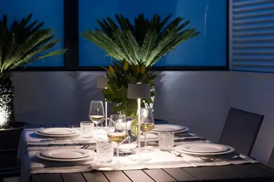 a table with white plates and glasses of wine at Dc Domus Charme SPA in Palermo