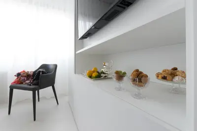 a white room with a table and a chair and bread at Dc Domus Charme SPA in Palermo