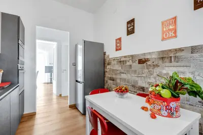 a kitchen with a white counter and a refrigerator at GuestHost - Residenza dei Poeti - Roomy and Modern Flat in Palermo