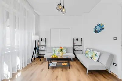 a living room with a couch and a table at GuestHost - Residenza dei Poeti - Roomy and Modern Flat in Palermo