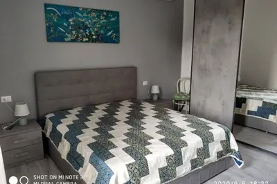 a bedroom with a bed and a painting on the wall at Home sweet home appartamento ricco di comfort in Palermo