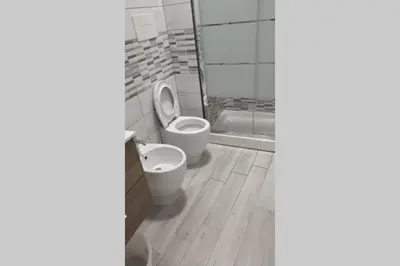 a bathroom with two toilets and a bath tub at Home sweet home appartamento ricco di comfort in Palermo